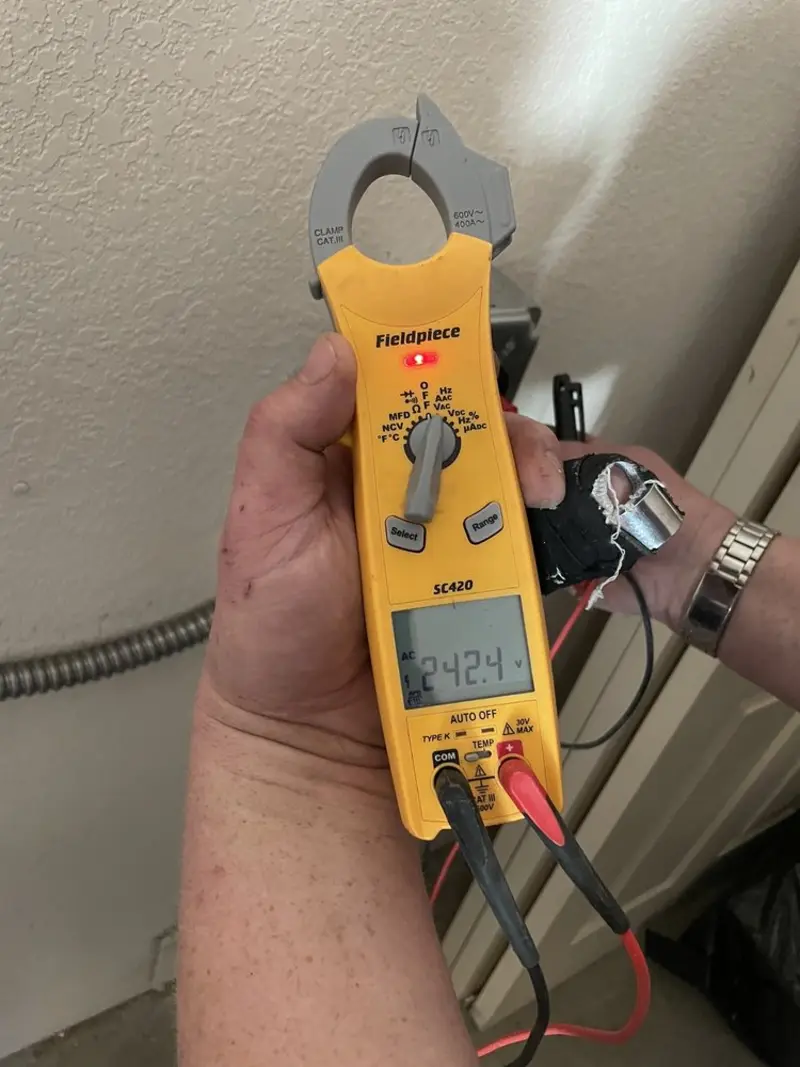 Voltage testing with clamp meter during Outlet Installation in Sullivan
